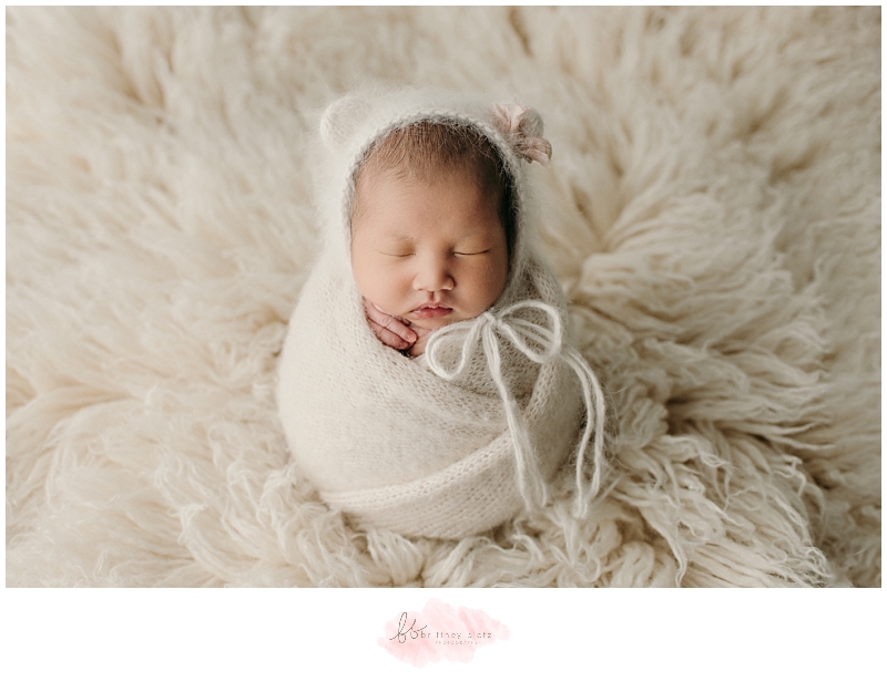 Calgary newborn photo baby girl in potato sack pose with fuzzy bear hat